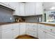 Bright kitchen features white cabinets, natural wood countertops, and stainless steel appliances at 715 Thompson Rd, Garner, NC 27529