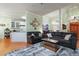 Spacious living room with hardwood floors, stylish sofas, and an open layout to the kitchen at 715 Thompson Rd, Garner, NC 27529