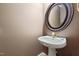 Powder room with pedestal sink, oval mirror, and neutral wall color at 715 Thompson Rd, Garner, NC 27529