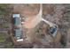 Expansive aerial view shows the property's layout, including the main house, outbuildings, driveway, and surrounding natural landscape at 721 Thompson Rd, Garner, NC 27529