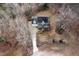 Aerial view of a charming two-story home featuring a well-manicured lawn and a long driveway nestled in a wooded area at 721 Thompson Rd, Garner, NC 27529