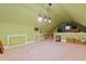 Spacious attic with carpet, sloped ceilings, and built in storage on the walls at 721 Thompson Rd, Garner, NC 27529