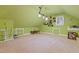 Spacious attic featuring neutral carpet, built-in storage, sloped ceilings and a vintage light fixture at 721 Thompson Rd, Garner, NC 27529