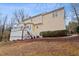 Spacious backyard with mature landscaping, deck, and stairs on a beautiful day at 721 Thompson Rd, Garner, NC 27529