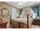 Inviting bedroom with a beautiful four-poster bed with floral wallpaper offering classic charm at 721 Thompson Rd, Garner, NC 27529
