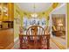 Cozy dining area with a wooden table and chairs, featuring a charming bay window and adjacent seating area at 721 Thompson Rd, Garner, NC 27529