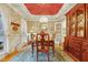 Traditional dining room with elegant floral wallpaper, a round wooden table, and a chandelier at 721 Thompson Rd, Garner, NC 27529