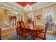 Dining area with a wood table set for four, complemented by bright, natural light from nearby windows at 721 Thompson Rd, Garner, NC 27529