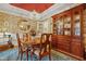 Charming dining room featuring wood table, chandelier, and a china cabinet with warm, inviting decor at 721 Thompson Rd, Garner, NC 27529