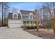 Traditional two-story home with attached garage, featuring manicured front yard and inviting entrance at 721 Thompson Rd, Garner, NC 27529