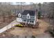 Aerial view of a charming two-story home with green shutters, a covered porch, and a well-maintained landscape at 721 Thompson Rd, Garner, NC 27529