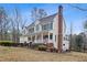 Exterior elevation showcasing a spacious home with a chimney and mature trees at 721 Thompson Rd, Garner, NC 27529