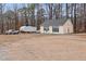 Detached two-door garage with beige exterior and a truck parked outside on a spacious lot surrounded by trees at 721 Thompson Rd, Garner, NC 27529