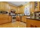 Spacious kitchen with stainless steel appliances, ample counter space, and wooden cabinets, perfect for cooking at 721 Thompson Rd, Garner, NC 27529
