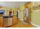 Bright kitchen with yellow walls, stainless steel appliances, and hardwood floors, offering a cheerful cooking space at 721 Thompson Rd, Garner, NC 27529