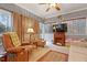 Cozy living room featuring large windows, a fireplace, and comfortable seating at 721 Thompson Rd, Garner, NC 27529