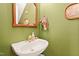 Charming powder room featuring a vintage sink and stylish green walls at 721 Thompson Rd, Garner, NC 27529