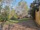 A well-maintained backyard featuring lawn, leafy trees and a shed at 725 Littleleaf Ct, Holly Springs, NC 27540