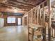 Partially finished basement featuring exposed framing, a walkout door, and concrete floors at 725 Littleleaf Ct, Holly Springs, NC 27540