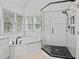 Bright bathroom featuring tub, shower, and natural light at 725 Littleleaf Ct, Holly Springs, NC 27540