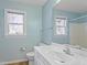 Bright bathroom with natural light, white vanity, and matching fixtures at 725 Littleleaf Ct, Holly Springs, NC 27540