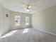 Spacious bedroom with neutral carpet, two windows, and ample natural light at 725 Littleleaf Ct, Holly Springs, NC 27540