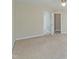 Empty bedroom with carpet, an open doorway, and plenty of natural light from the windows at 725 Littleleaf Ct, Holly Springs, NC 27540