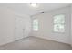 Bright bedroom featuring closet space and two windows at 725 Littleleaf Ct, Holly Springs, NC 27540