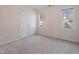 Cozy bedroom featuring neutral carpet, double door closet and bright windows at 725 Littleleaf Ct, Holly Springs, NC 27540