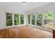 The breakfast nook is airy and bright with hardwood floors and lots of windows to the outside at 725 Littleleaf Ct, Holly Springs, NC 27540