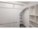Spacious walk-in closet with ample storage space and custom shelving at 725 Littleleaf Ct, Holly Springs, NC 27540