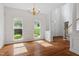Bright dining area with hardwood floors, large windows and white columns, creating an open and inviting space at 725 Littleleaf Ct, Holly Springs, NC 27540