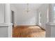 Dining area featuring hardwood floors, large windows for ample natural light, and classic chandelier at 725 Littleleaf Ct, Holly Springs, NC 27540