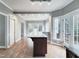 Open dining area featuring a center island, hardwood floors, and backyard access at 725 Littleleaf Ct, Holly Springs, NC 27540