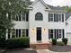 Charming white two-story home with black shutters and manicured landscaping at 725 Littleleaf Ct, Holly Springs, NC 27540
