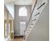 Spacious foyer with soaring ceilings, a large arched window, and a staircase with white railings at 725 Littleleaf Ct, Holly Springs, NC 27540