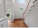 Bright foyer with hardwood floors, white columns, a staircase and a large window, creating a grand entrance at 725 Littleleaf Ct, Holly Springs, NC 27540