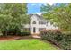Charming two-story home with a well-manicured lawn and mature landscaping, creating an inviting curb appeal at 725 Littleleaf Ct, Holly Springs, NC 27540