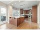 Kitchen island features granite countertops and beautiful wood floors; a chef's dream! at 725 Littleleaf Ct, Holly Springs, NC 27540
