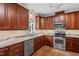 Updated kitchen with stainless steel appliances, granite countertops, and a large window above the sink at 725 Littleleaf Ct, Holly Springs, NC 27540