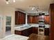 Gourmet kitchen featuring stainless steel appliances, and rich wood cabinetry at 725 Littleleaf Ct, Holly Springs, NC 27540