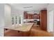 Open-concept kitchen with large island, granite countertops, stainless steel appliances and deck access at 725 Littleleaf Ct, Holly Springs, NC 27540