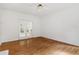 Bright living room with hardwood floors and doors to the outside that give a cozy, light-filled ambiance at 725 Littleleaf Ct, Holly Springs, NC 27540