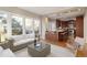 Open concept living room and kitchen with large windows providing abundant natural light and backyard views at 725 Littleleaf Ct, Holly Springs, NC 27540