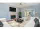 Inviting living room with modern decor, fireplace, and open access to a sunroom, perfect for relaxation and entertainment at 725 Littleleaf Ct, Holly Springs, NC 27540