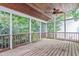 Enjoy the outdoors on this screened porch with a ceiling fan and wooded views at 725 Littleleaf Ct, Holly Springs, NC 27540