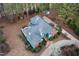 An elevated shot revealing a well-maintained home with an expansive yard, mature trees, and outdoor living areas at 725 Thompson Rd, Garner, NC 27529