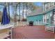Spacious wood deck with a grill, white railing and wooded views creating a perfect space for outdoor gatherings at 725 Thompson Rd, Garner, NC 27529
