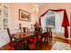 Dining area with custom display cabinet, hardwood floors, and large windows adding charm to meal times at 725 Thompson Rd, Garner, NC 27529