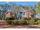 Attractive blue and red brick home with a well-kept lawn and lush green bushes under a bright sky at 725 Thompson Rd, Garner, NC 27529